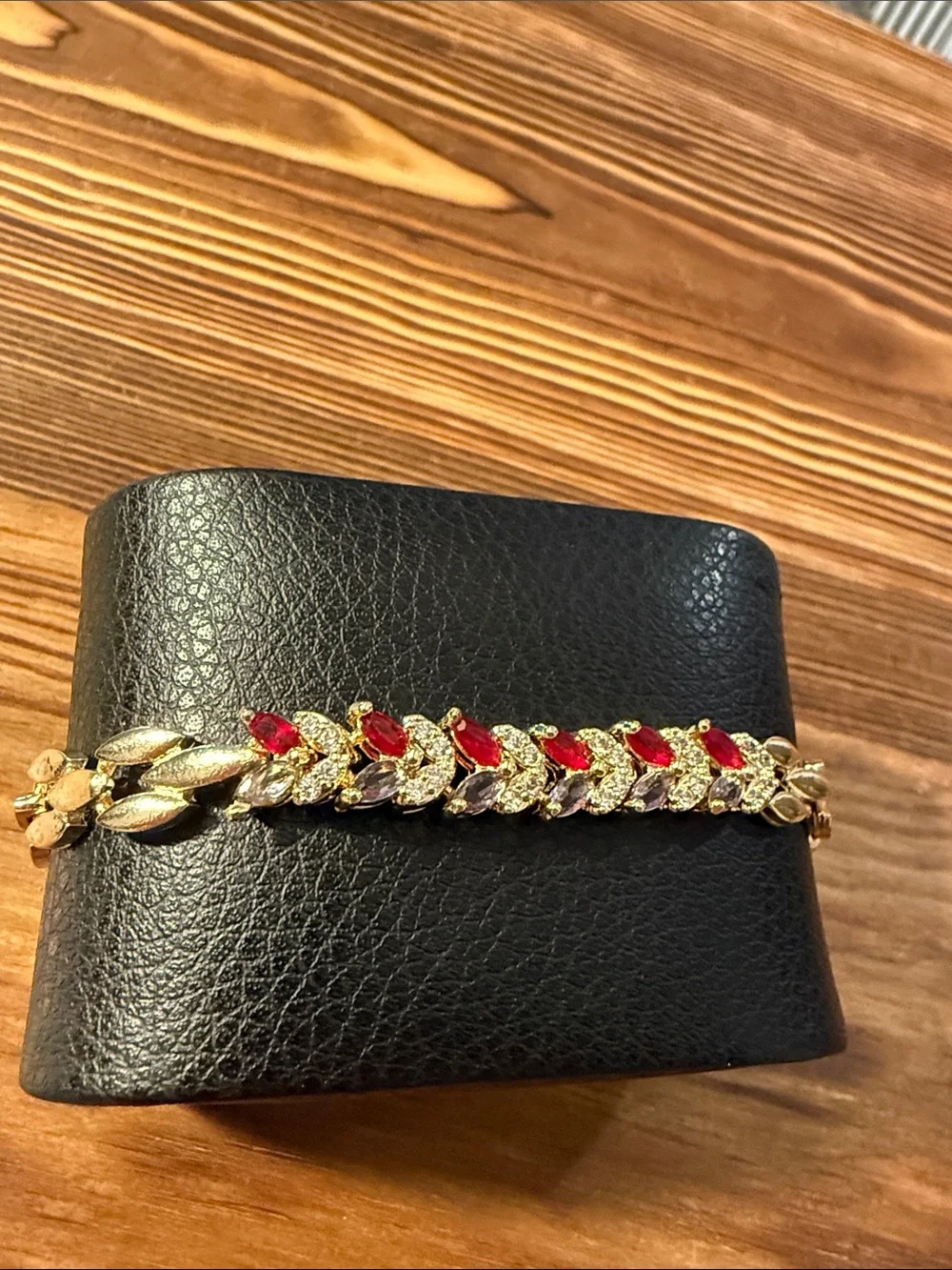 Gold-Tone Bracelet with Red Gem Leaf Accents